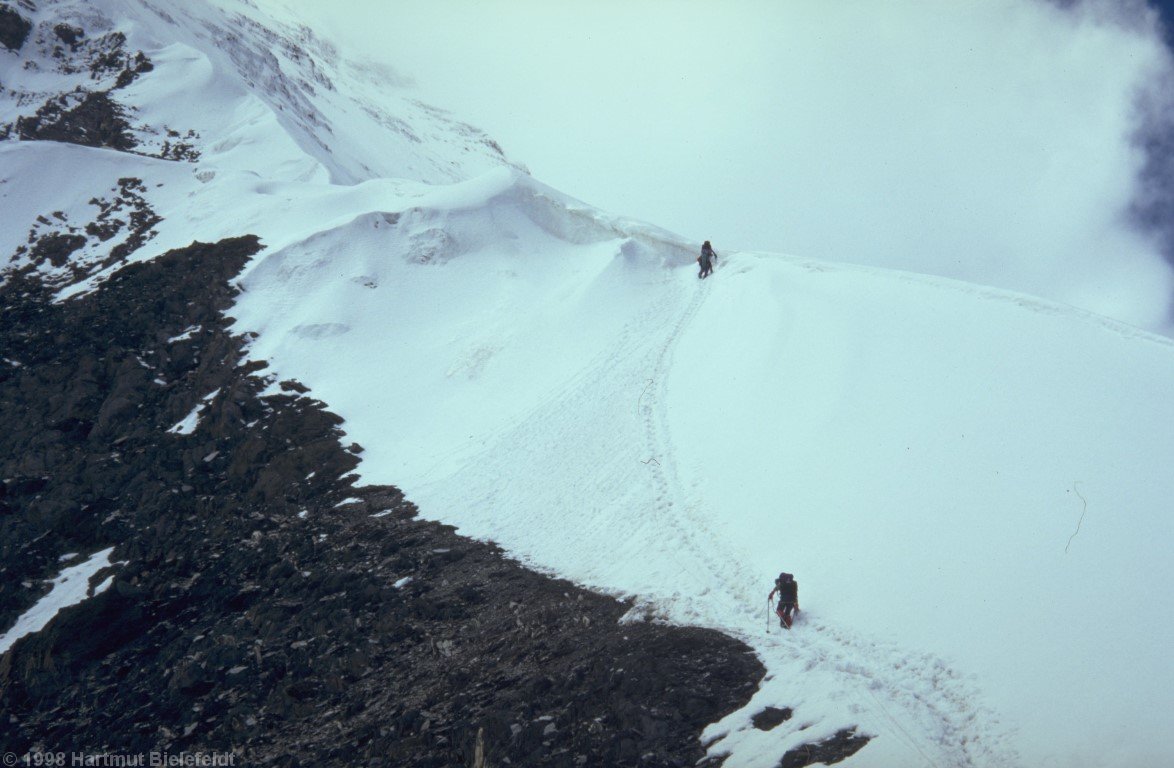 The final slope is steep and icy, so we welcome the fixed rope.
