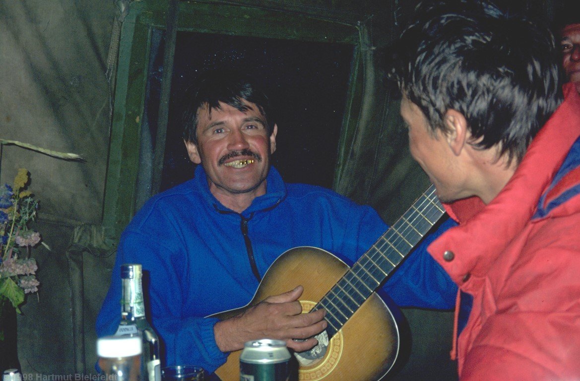 Mountain guide Jurij celebrates the summit with a group; to be on the safe side we join their celebration.